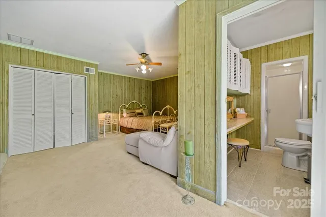 a bathroom with a granite countertop sink and a toilet