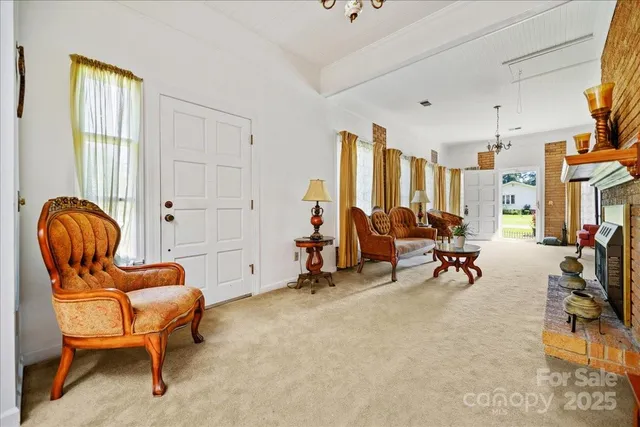 a living room with furniture a rug and a window