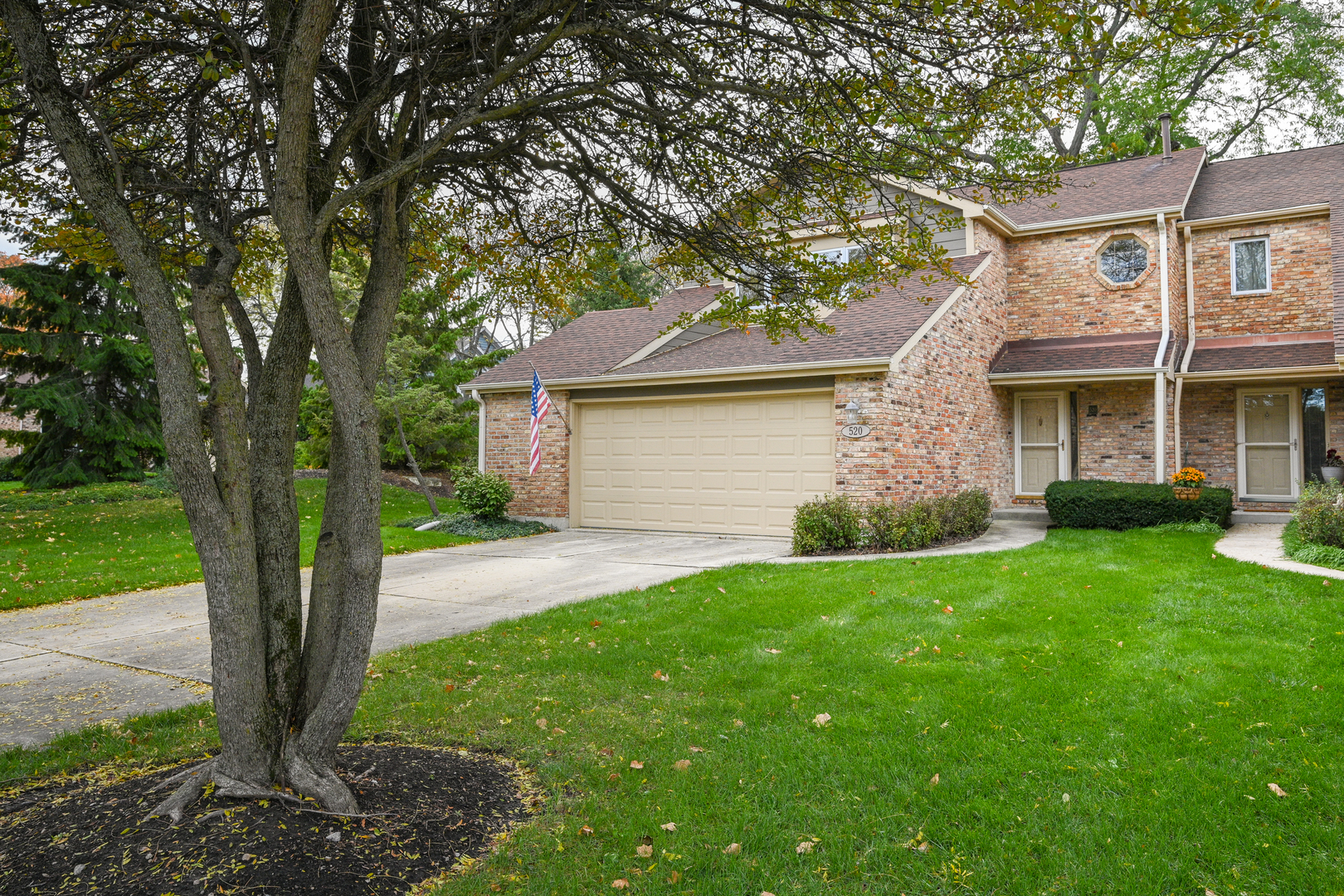 520 Renn Court Wheaton, IL 60187 - Photo 2 of 33 a front view of a house with a garden and yard