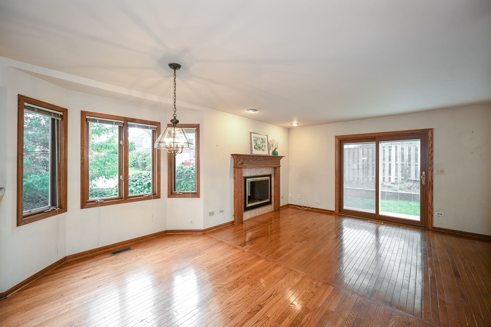 520 Renn Court Wheaton, IL 60187 - Photo 11 of 33 a view of an empty room with a window and wooden floor