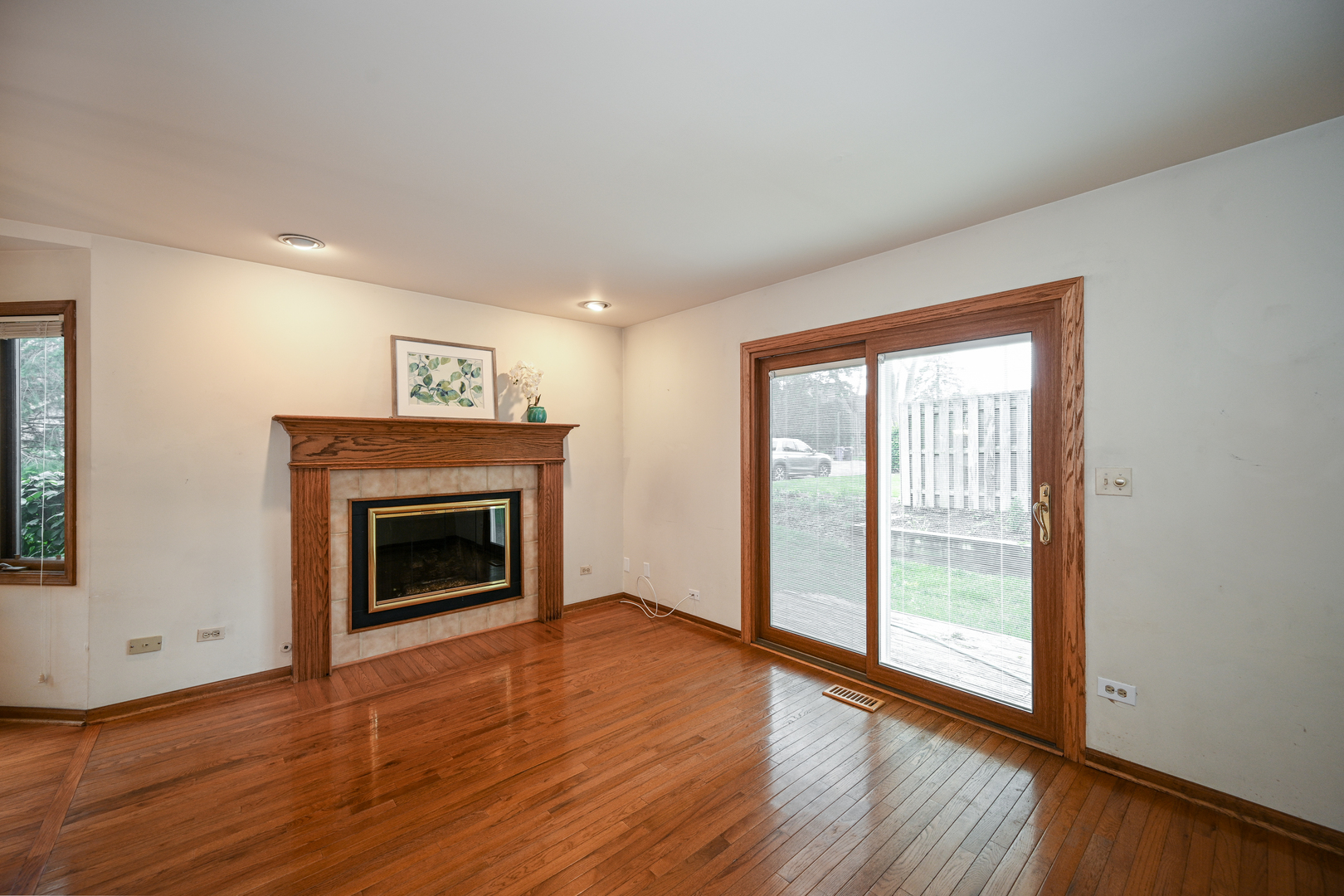 520 Renn Court Wheaton, IL 60187 - Photo 13 of 33 a view of an empty room with wooden floor fireplace and a window
