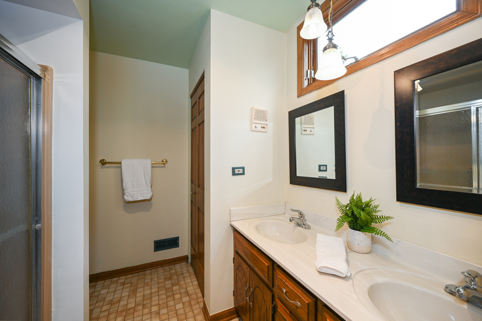 520 Renn Court Wheaton, IL 60187 - Photo 23 of 33 a bathroom with a granite countertop sink a mirror and a shower