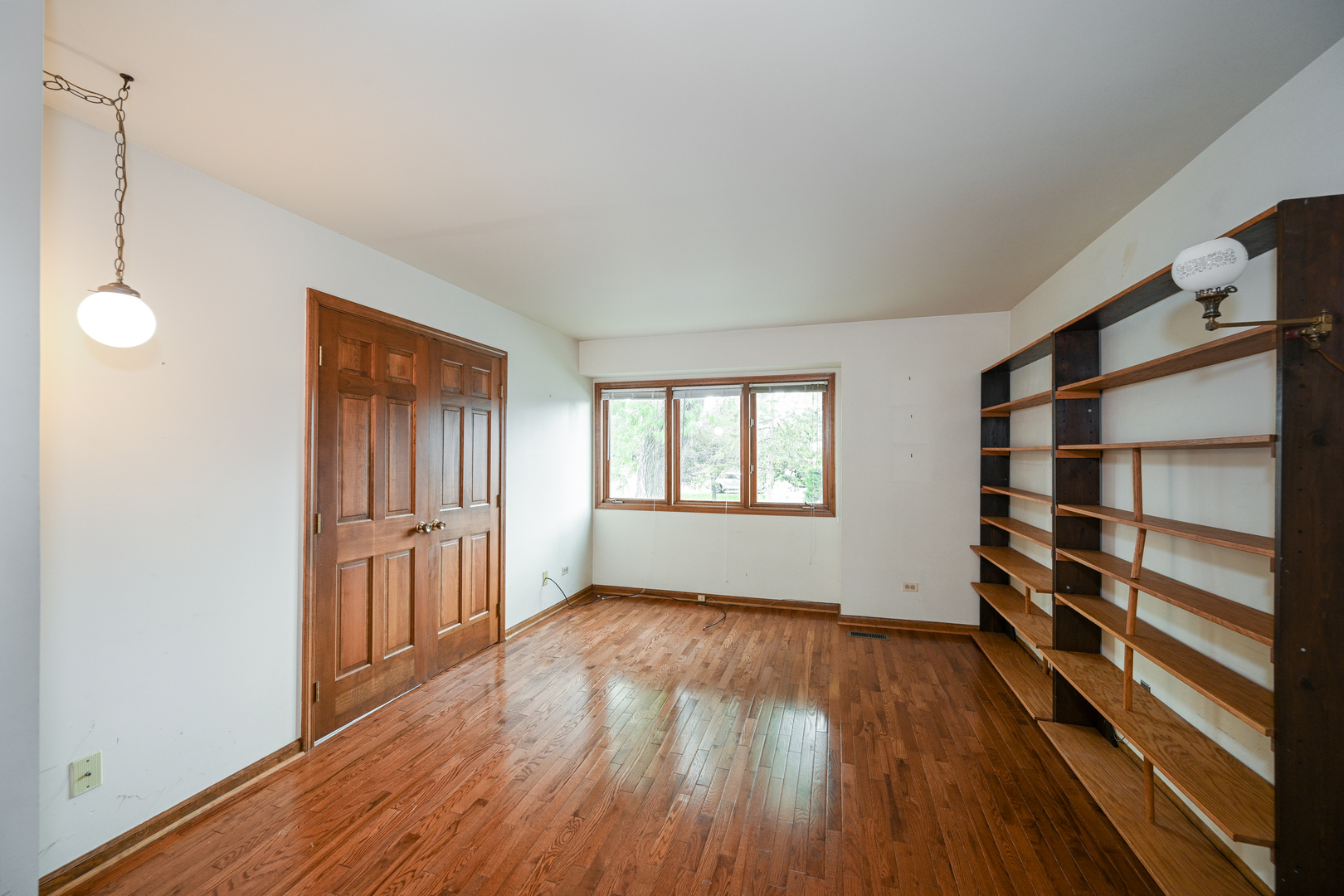 520 Renn Court Wheaton, IL 60187 - Photo 25 of 33 a view of an empty room with a window and wooden floor