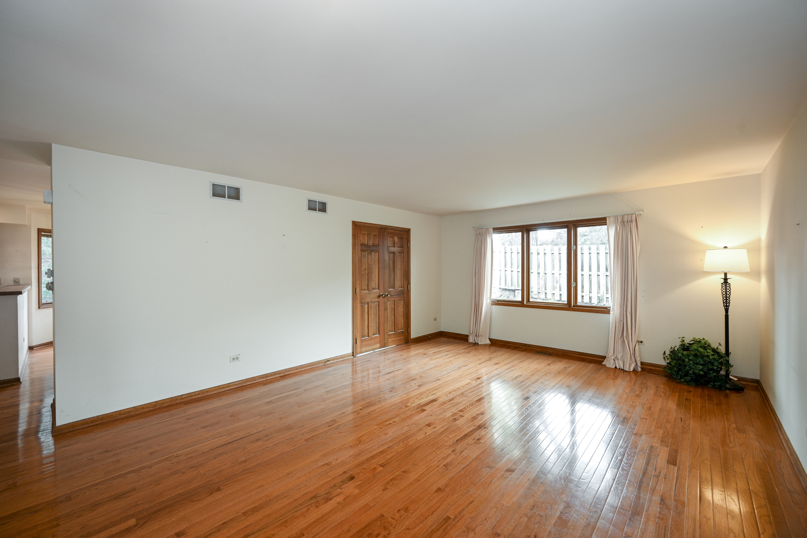 520 Renn Court Wheaton, IL 60187 - Photo 5 of 33 a view of a room with wooden floor and a window