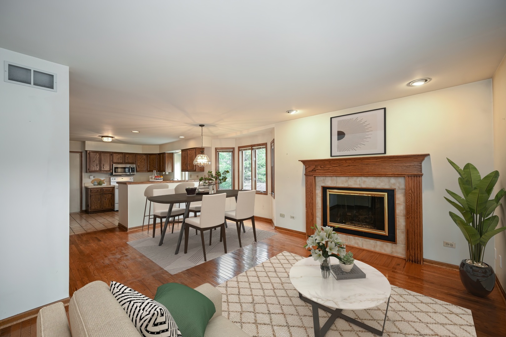 520 Renn Court Wheaton, IL 60187 - Photo 10 of 33 a living room with furniture a fireplace and a table