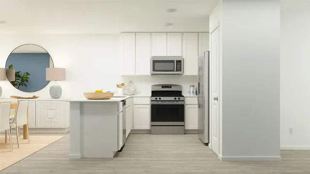 a kitchen with stainless steel appliances a stove refrigerator and a microwave
