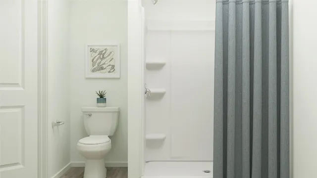 a white toilet sitting next to a bathroom sink