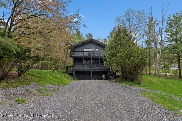 a front view of a house with a garden and yard