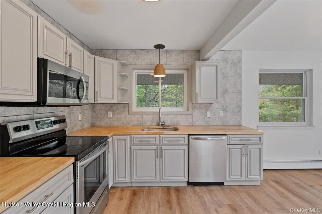 2 Mountain Valley Road Boiceville, NY 12412 - Photo 21 of 42 a kitchen with stainless steel appliances white cabinets a sink and a stove