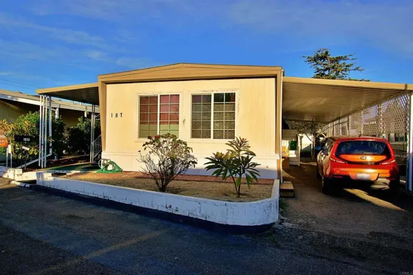 a view of a house with a cars park