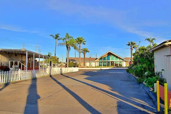 a view of house with swimming pool and seating space