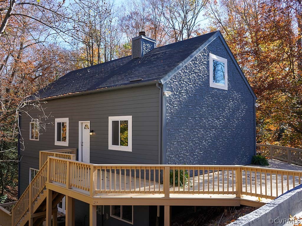a view of a house with a wooden deck