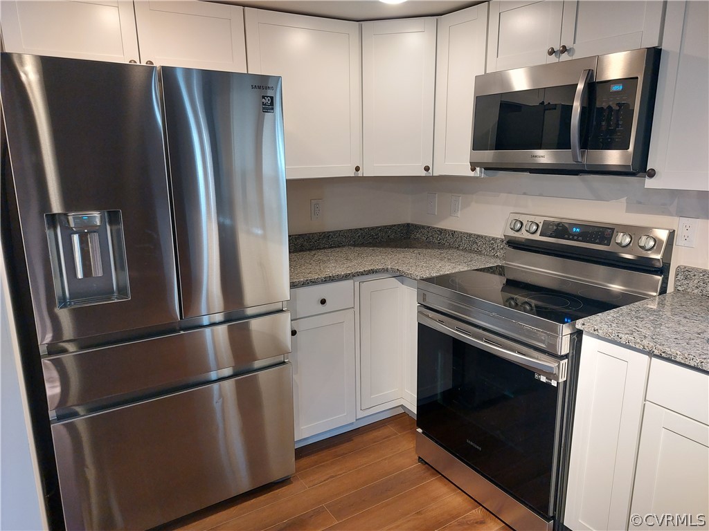 3717 Pfost Avenue Prince George, VA 23875 - Photo 32 of 39 a kitchen with stainless steel appliances granite countertop a refrigerator microwave and sink