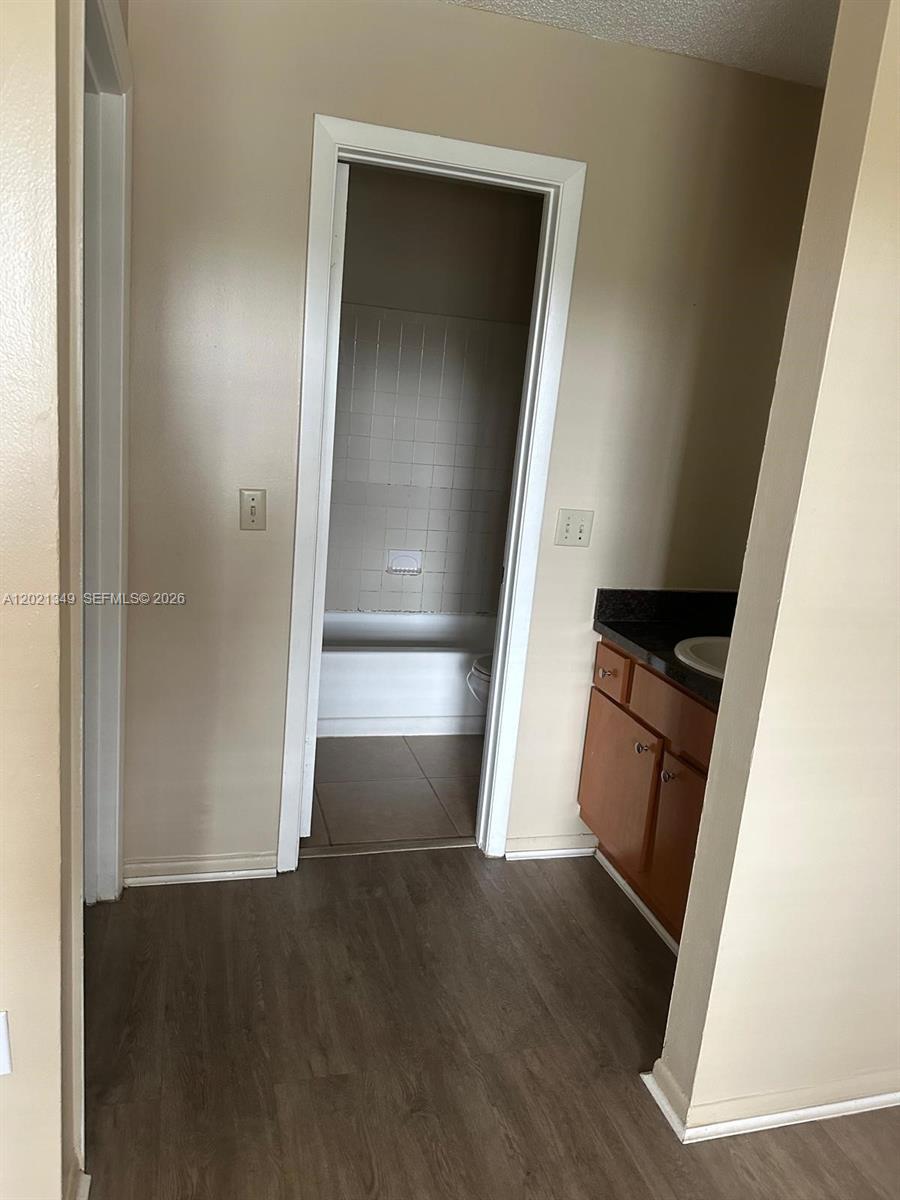 4481 West McNab Road, Unit 37 Pompano Beach, FL 33069 - Photo 16 of 20 an empty room with wooden floor and windows