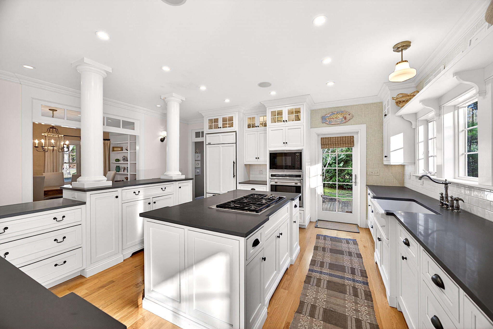 205 Little River Road Cotuit, MA 02635 - Photo 12 of 60 a kitchen with stainless steel appliances kitchen island granite countertop a stove a sink and a refrigerator