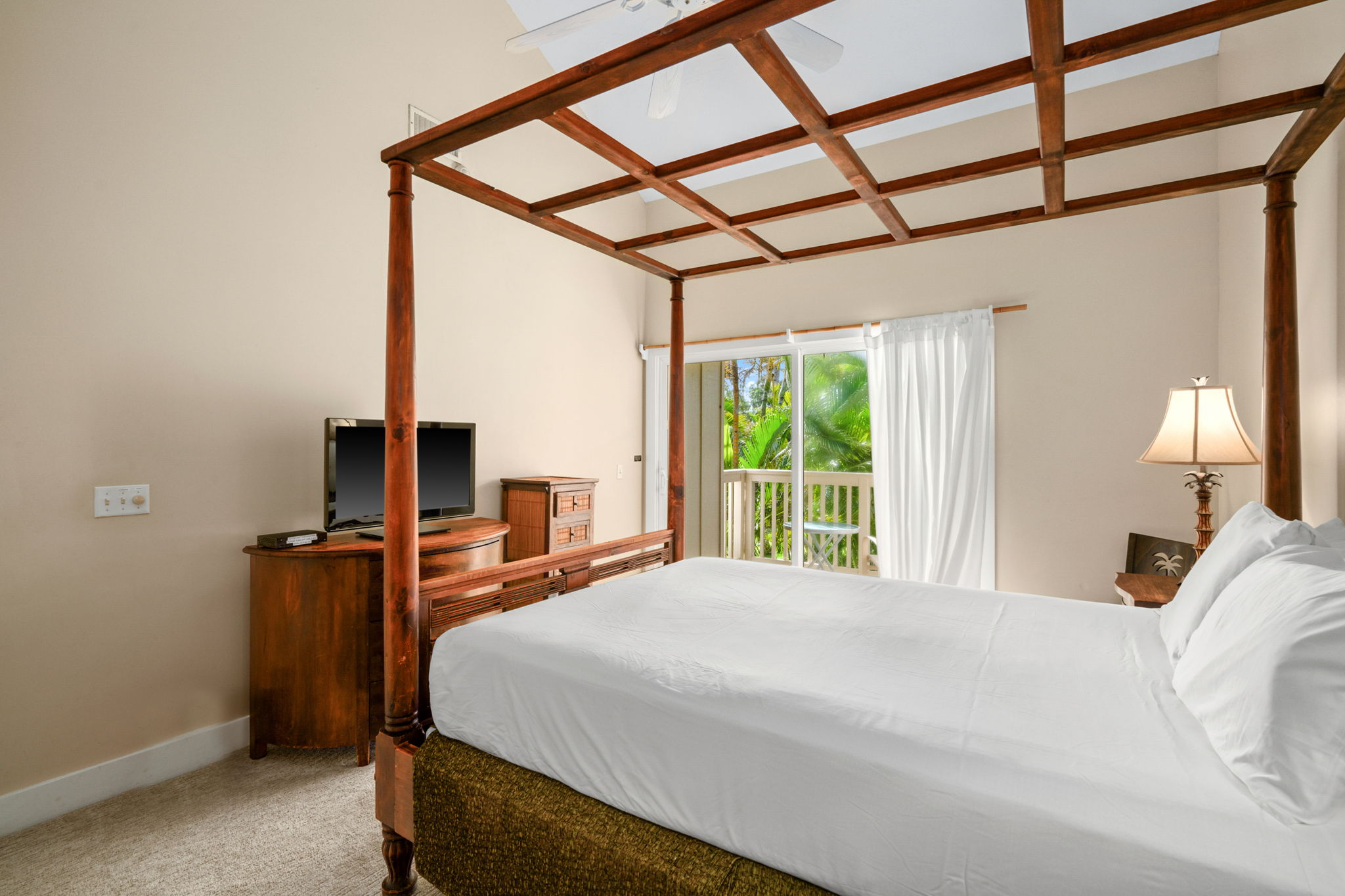 1831 Poipu Road, Unit 823 Koloa, HI 96756 - Photo 14 of 30 a bedroom with a bed and large windows