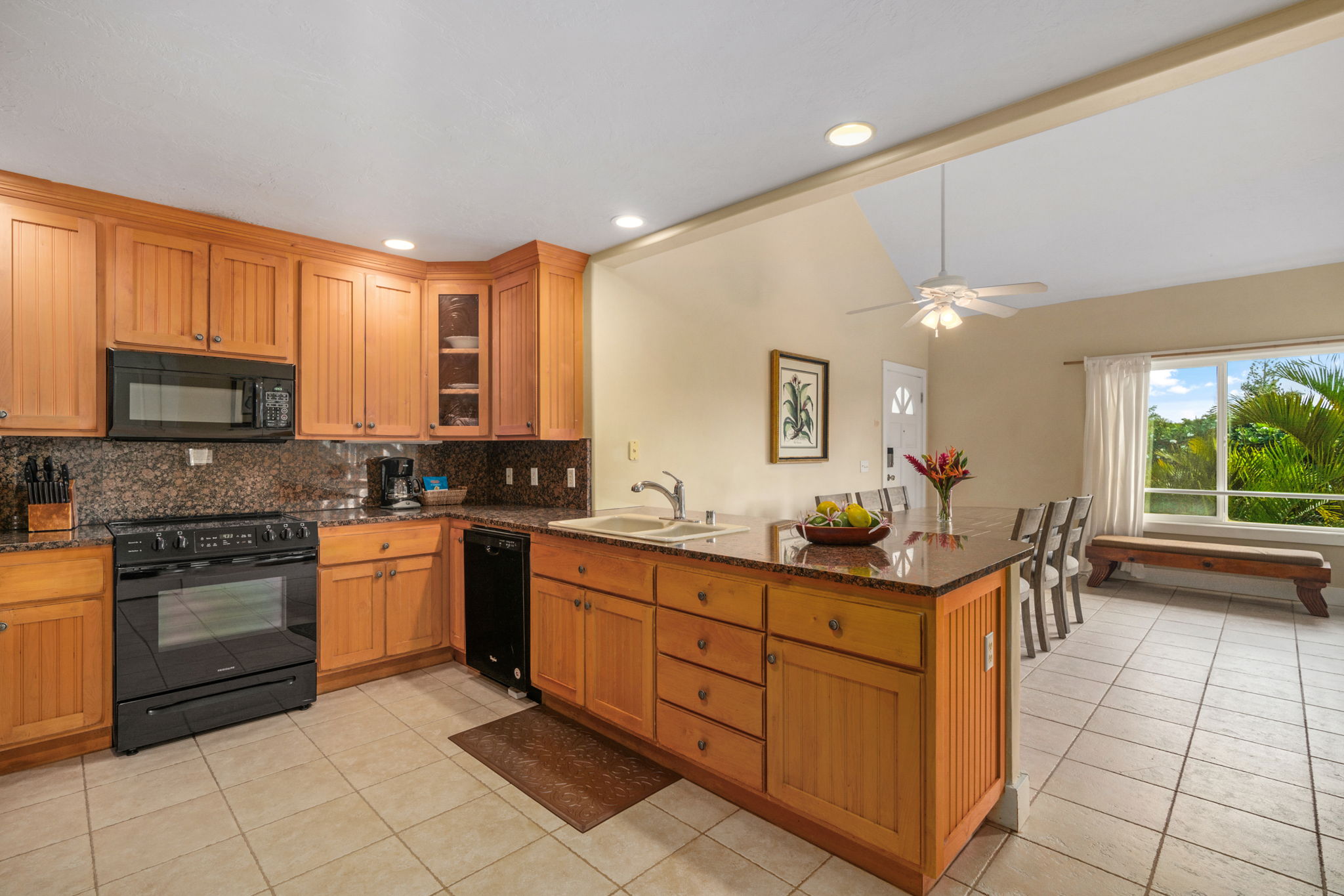 1831 Poipu Road, Unit 823 Koloa, HI 96756 - Photo 2 of 30 a kitchen with stainless steel appliances granite countertop a stove a sink and a microwave