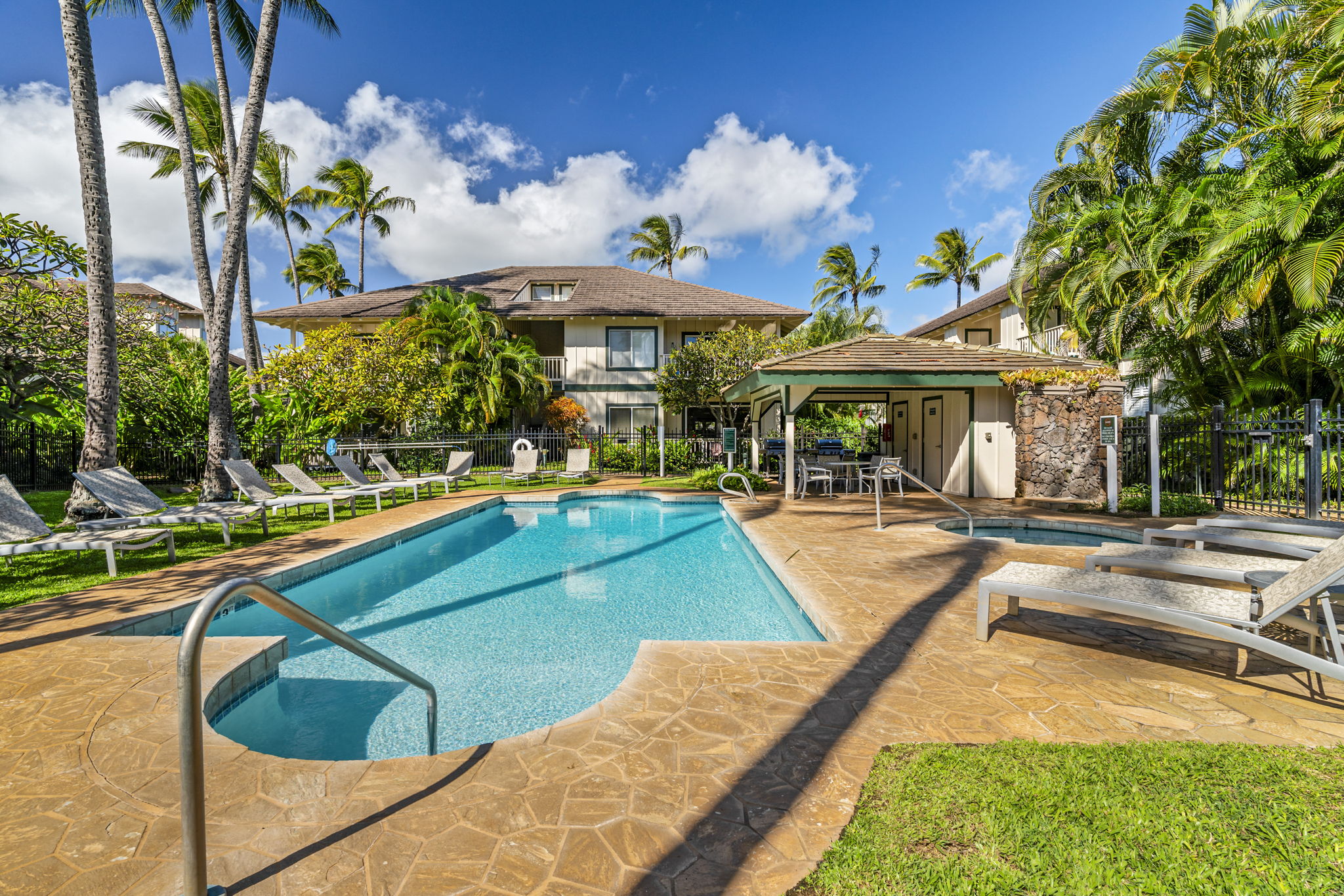 1831 Poipu Road, Unit 823 Koloa, HI 96756 - Photo 30 of 30 a view of a swimming pool with lounge chairs