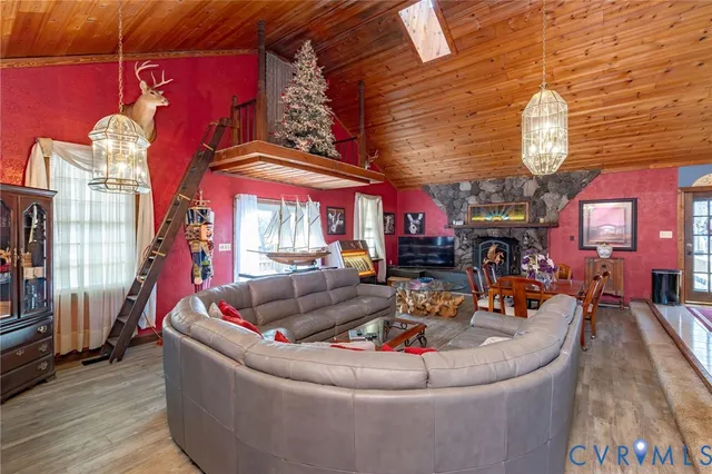 a kitchen with stainless steel appliances kitchen island granite countertop a table chairs in it and a window