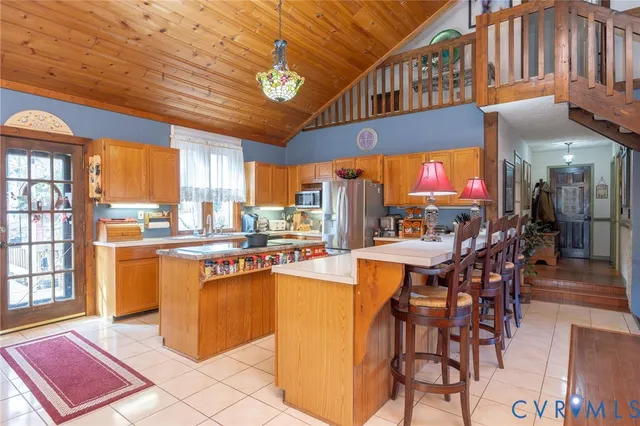 a dining hall with granite countertop a stove and cabinets