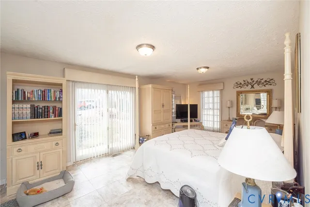 a spacious bathroom with a granite countertop sink a toilet a mirror and shower