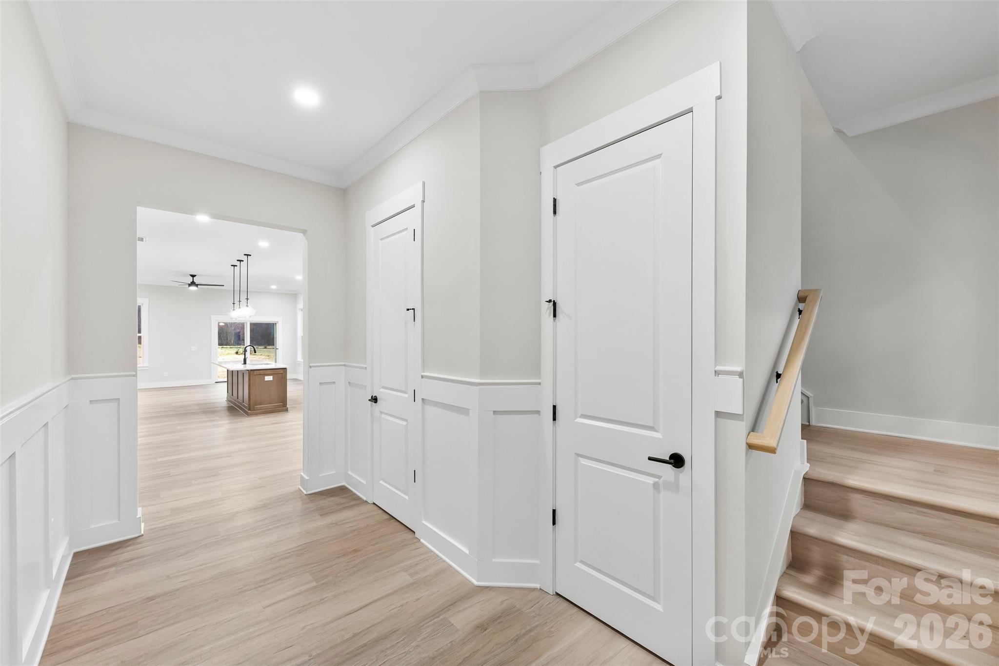 551 Perry Road Troutman, NC 28166 - Photo 5 of 47 a view of a hallway with wooden floor and staircase