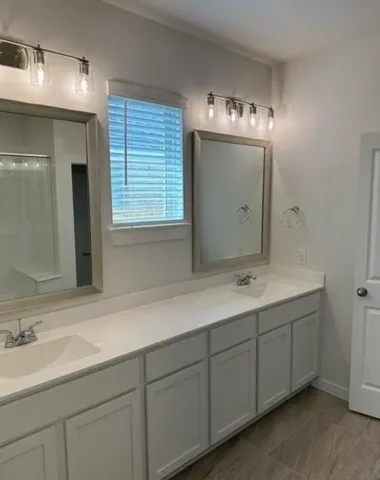 a bathroom with a sink and mirror