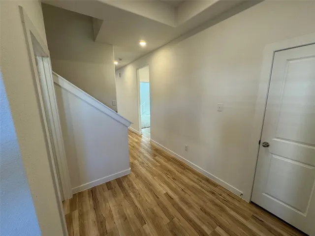 a large kitchen with stainless steel appliances granite countertop a stove a sink dishwasher and a refrigerator with wooden floor