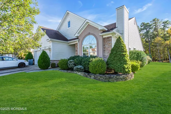 a front view of a house with a garden