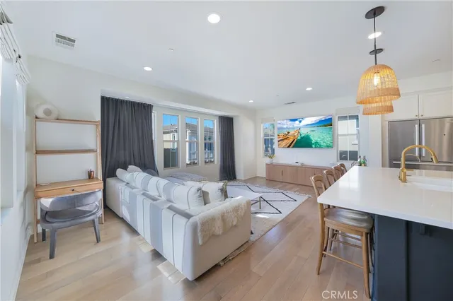 a living room with furniture and a chandelier