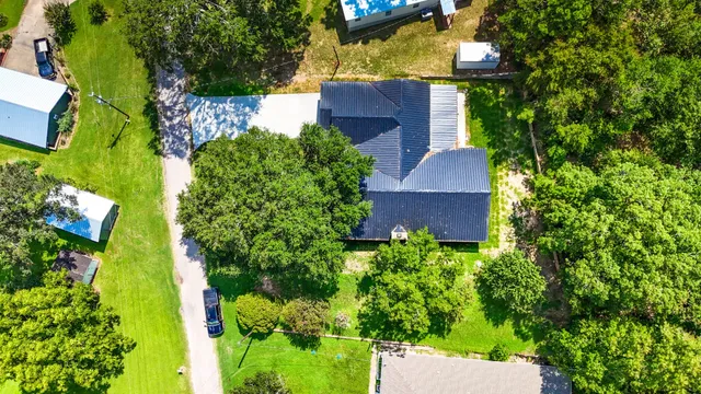 an aerial view of house with yard swimming pool and outdoor seating