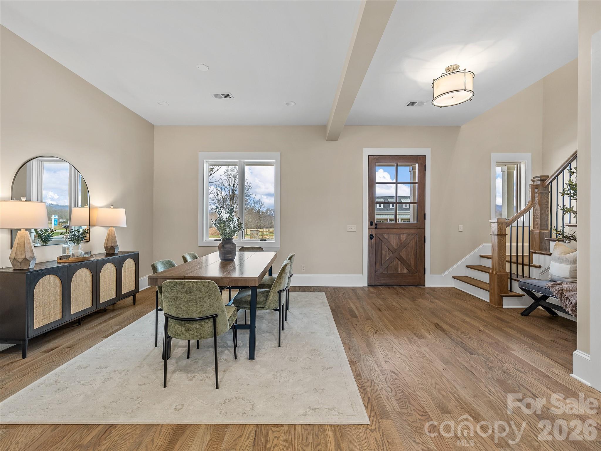 297 Mountain Meadows Lane, Unit 7 Tryon, NC 28782 - Photo 15 of 47 a view of a dining room with furniture and a window