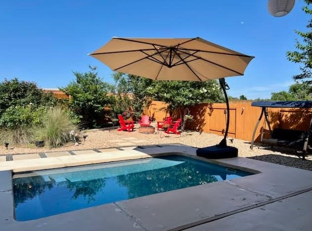 a view of patio with a table and chairs under an umbrella