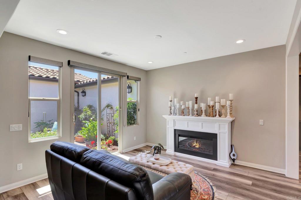 22005 Long Trot Drive Escondido, CA 92029 - Photo 16 of 51 a living room with furniture and a fireplace