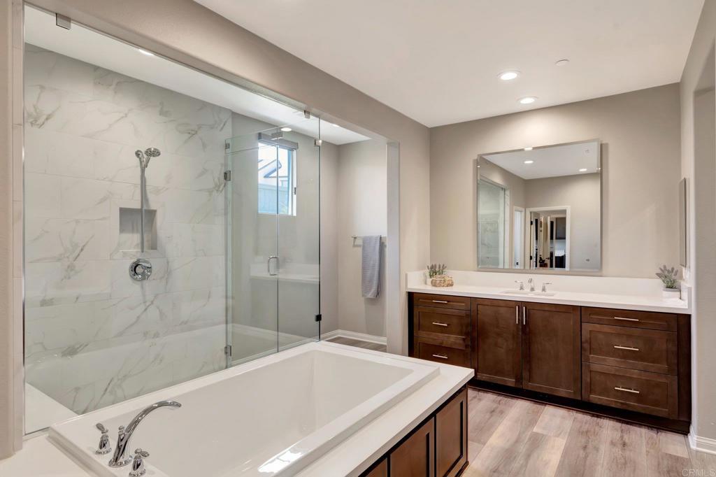 22005 Long Trot Drive Escondido, CA 92029 - Photo 22 of 51 a spacious bathroom with a bathtub shower sink mirror and toilet