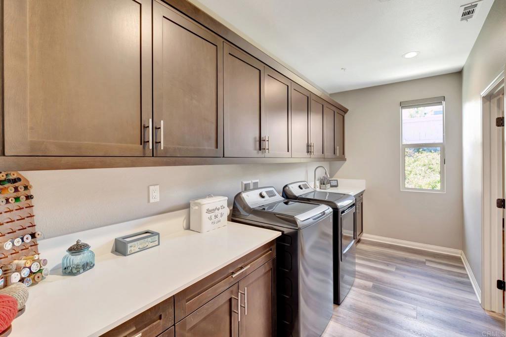 22005 Long Trot Drive Escondido, CA 92029 - Photo 23 of 51 a kitchen with a sink a stove cabinets and wooden floor