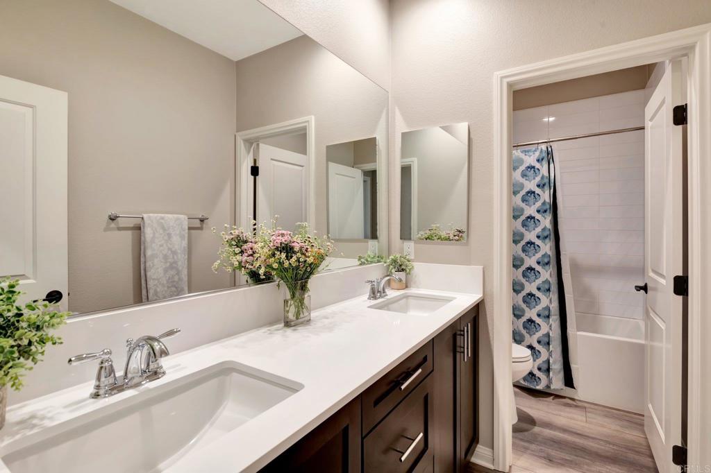 22005 Long Trot Drive Escondido, CA 92029 - Photo 30 of 51 a bathroom with a sink and a mirror