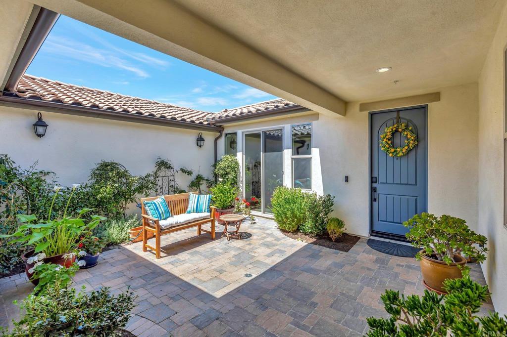 22005 Long Trot Drive Escondido, CA 92029 - Photo 3 of 51 a house with potted plants in front of it