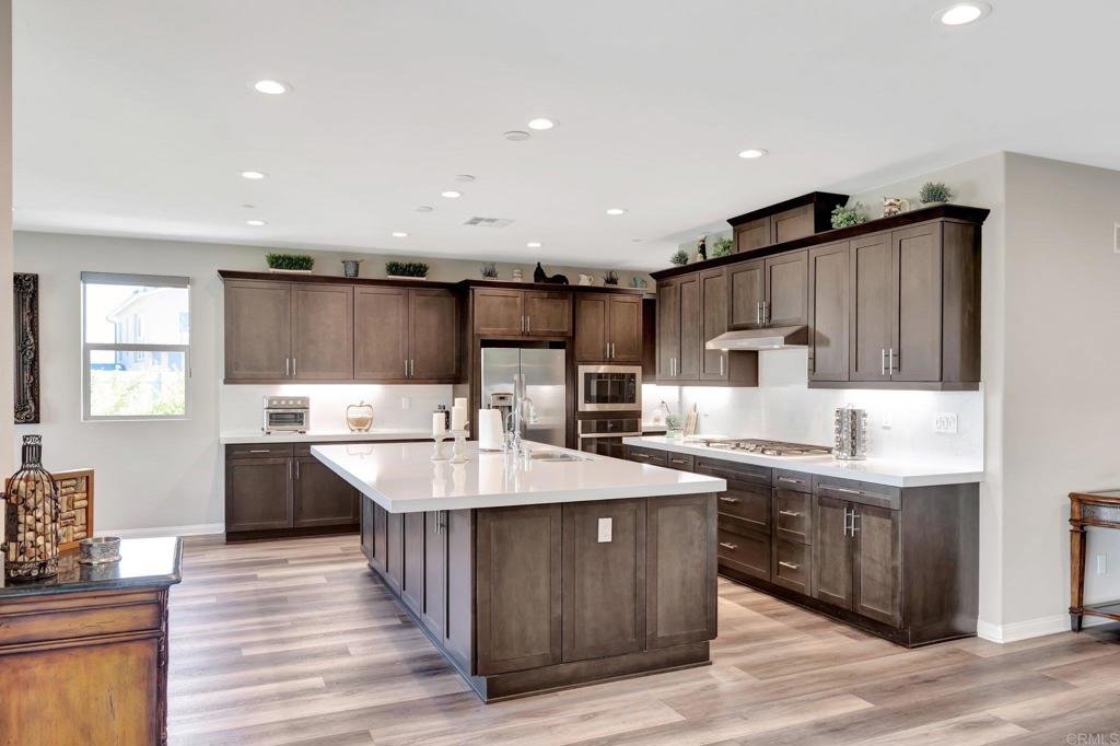22005 Long Trot Drive Escondido, CA 92029 - Photo 6 of 51 a kitchen with counter top space cabinets and center island