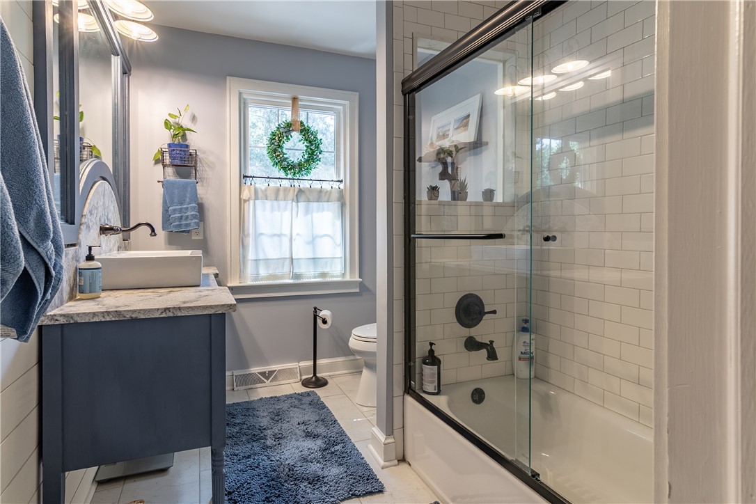 620 Seminole Point Road Fair Play, SC 29643 - Photo 15 of 50 A classic tiled shower tub combo complements the vanity in this tastefully designed bathroom.