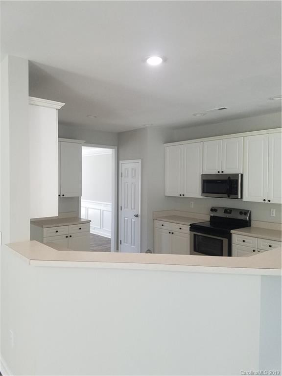 1450 Autumn Ridge Lane Fort Mill, SC 29708 - Photo 11 of 41 a kitchen with stainless steel appliances a stove a sink a microwave and cabinets