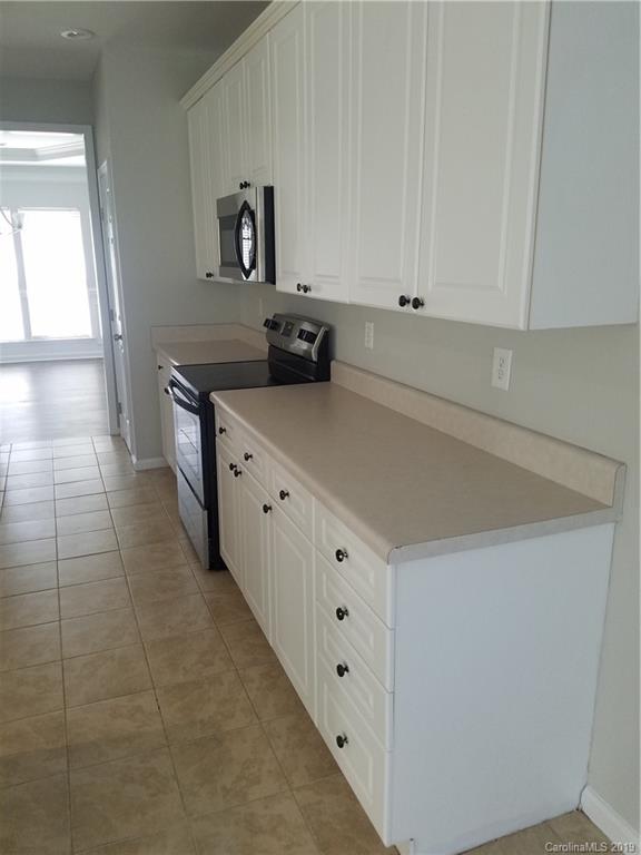 1450 Autumn Ridge Lane Fort Mill, SC 29708 - Photo 12 of 41 a kitchen with cabinets and a stove top oven