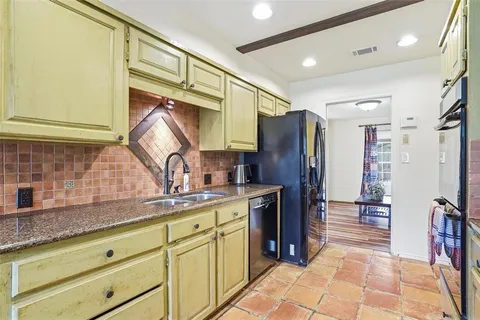 a large kitchen with stainless steel appliances granite countertop a stove and a sink