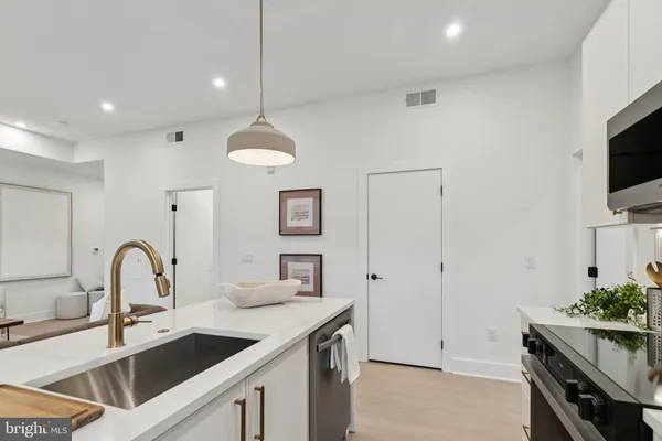 a kitchen with a sink and a refrigerator