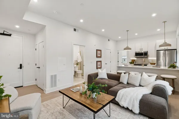a view of a living room kitchen and a wooden floor
