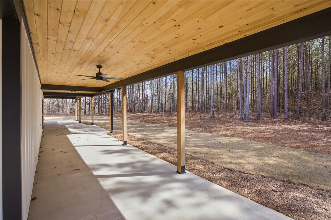147 McAlister Road West Union, SC 29696 - Photo 35 of 49 Enjoy the tranquil wooded views from this expansive covered patio, perfect for outdoor living.