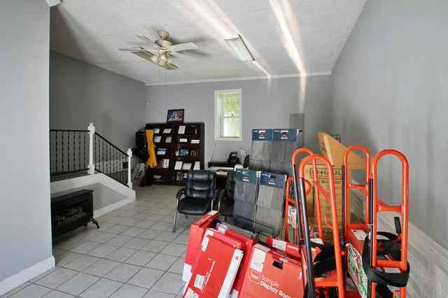 a view of a workspace with furniture and a window