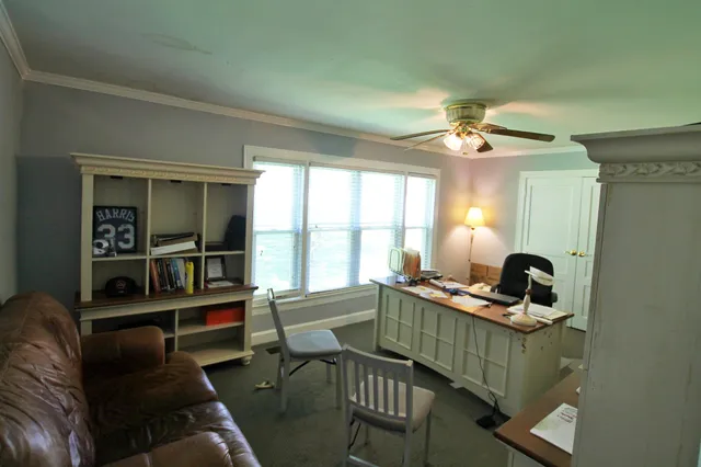 a workspace with chandelier and a window