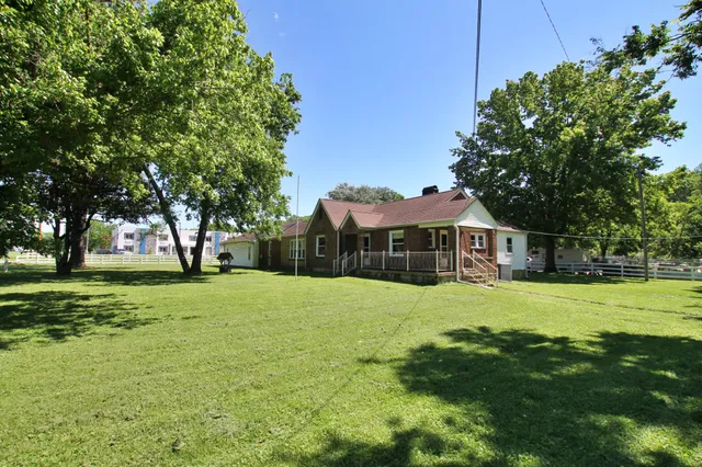 a yellow house in middle of the forest