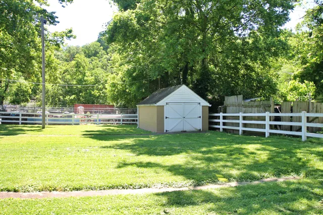 a view of a house with a yard and sitting area